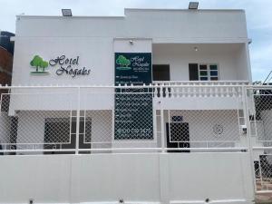 a white building with a sign on it at Hotel Nogales Riohacha in Ríohacha