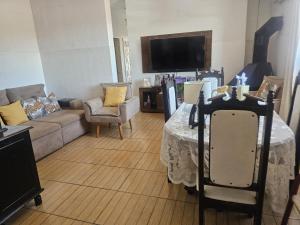 a living room with a table and a couch at Casa da bisa Élida in São Gabriel