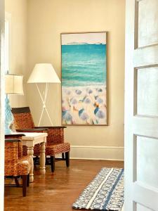 a living room with a desk and a painting on the wall at Sun & Fun Oceanfront Saint Augustine Beach! in Saint Augustine +57 photos