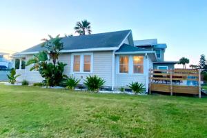 a small white house with a yard at Sun & Fun Oceanfront Saint Augustine Beach! in St. Augustine