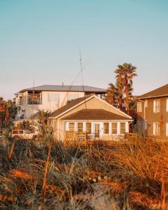 a house sitting on top of a field of grass at Sun & Fun Oceanfront Saint Augustine Beach! in Saint Augustine