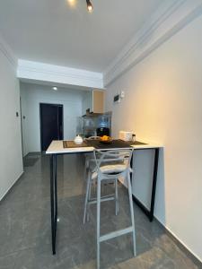 a kitchen with a counter with two stools in it at Sapphire in Nairobi