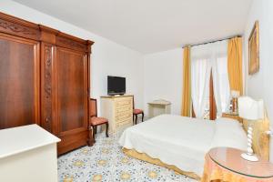 Postel nebo postele na pokoji v ubytování Hotel Villa Sirio