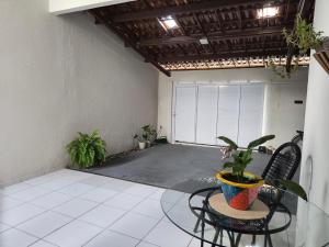 an empty garage with two chairs and a potted plant at Casa Serena - Quarto in Camocim