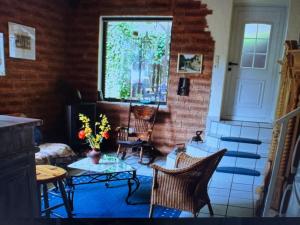 a living room with chairs and a table and a window at Ferienwohnung Danielle Kessler in Idar-Oberstein