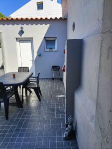 a patio with a table and a table and chairs at Casas Sao Sebastiao in Évora