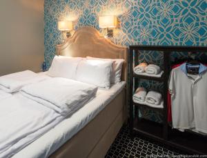 a bed with white pillows and towels in a room at Cocorico Bed and Breakfast OLD TOWN Szczecin Adults Only in Szczecin +13 photos