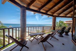 a porch with chairs and a view of the beach at Indigo Belize 5C condo in San Pedro