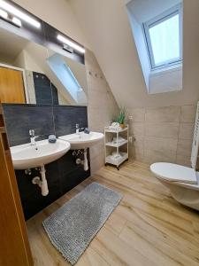 a bathroom with two sinks and a skylight at SK family - Ubytování v rodinném domě in Týn nad Vltavou +28 photos