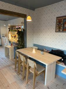 a wooden table and chairs in a room at Hedvigs Restaurang in Delsbo