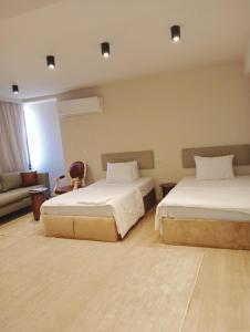 a hotel room with two beds and a couch at The magnificence of Zamalek in Cairo