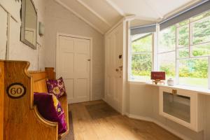 a living room with a window and a chair at The Coach House in Stirling