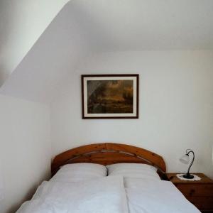 a bedroom with a bed with a picture on the wall at Ferienhof am Ipf in Bopfingen