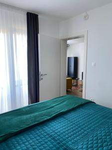 a bedroom with a bed with a green bedspread at Villa Sunny Alley - Sunčani Sokak in Sarajevo +15 photos