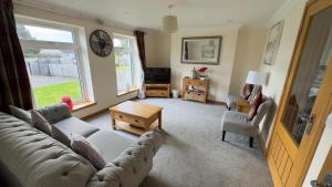a living room with a couch and a table at The Waverley Inn Holiday Homes in Inverness
