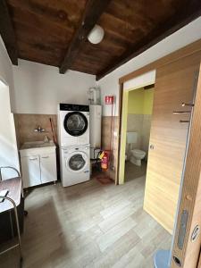 a laundry room with a washing machine and a washer at Segarati Relax Ca Perdissi in Bardi +16 photos