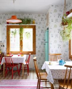 a dining room with a table and chairs at Solvillan in Korppoo
