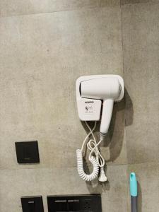 a white phone is hanging on a wall at Supernova Spira 39th floor Sec 94 Noida in Noida