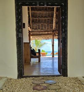 an open door to a room with a view of the ocean at HA Beach Boutique - Adults Only in Jambiani