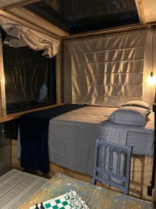 a bedroom with a bed in a tent at Tree House in Balneário Camboriú +5 photos