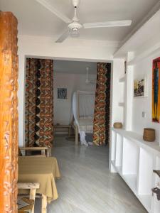 a living room with a table and a chair at Samia House in Jambiani +38 photos