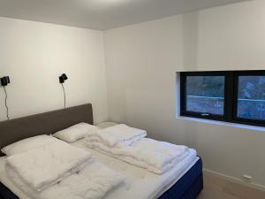un letto in una camera con due cuscini sopra di Exclusive apartment in Kristiansand - Høllen a Kristiansand