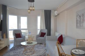 a living room with a couch and chairs and a table at King Suite SS18 in Istanbul