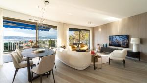 a living room with a couch and a table and chairs at Riviera luxury estates in Antibes