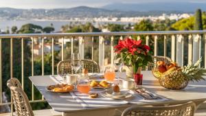 a table with food and drinks on a balcony at Riviera luxury estates in Antibes