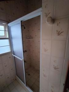 a shower with a glass door in a bathroom at Chalet PA La Perla MAR DEL EDÉN in Mar del Plata