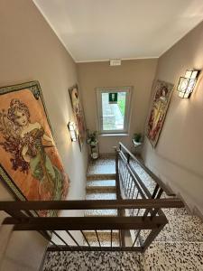 a stairway with a painting on the wall and a mural at Bardi al Riolo Olivo appt in Bardi