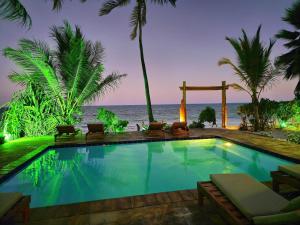 a swimming pool with a view of the ocean at HA Beach Boutique - Adults Only in Jambiani +45 photos