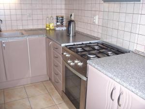 a kitchen with a stove top oven next to a sink at Eden Apartment Budapest in Budapest
