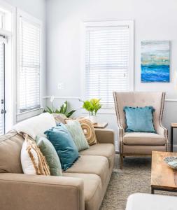 a living room with a couch and a chair at Private Rooftop & Parking - 3 Blocks to King St in Charleston