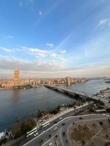 a view of a river with a bridge and a city at Nile Star Suites &Apartment in Cairo