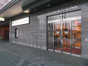 a store front of a building with glass doors at Hotel Route-Inn Hirosaki Ekimae in Hirosaki