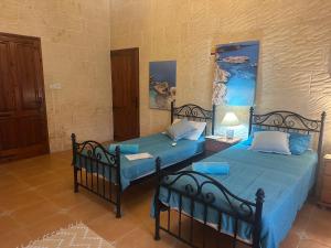 Postel nebo postele na pokoji v ubytování Gozo Sunset Farmhouse