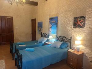 Postel nebo postele na pokoji v ubytování Gozo Sunset Farmhouse