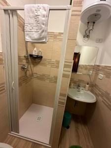 a small bathroom with a shower and a sink at Nonno Leo in San Massimo +18 photos
