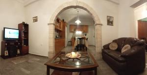 a living room with a couch and a table at Kalotina's House in Kalymnos