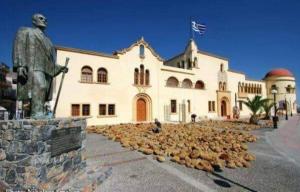 a large building with a statue in front of it at Kalotina's House in Kalymnos