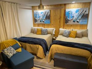 a small room with two beds and a couch at La Mia Casa II in Sarasota