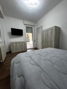 a bedroom with a large bed and a flat screen tv at Malù23 B&B Lumezzane in Lumezzane