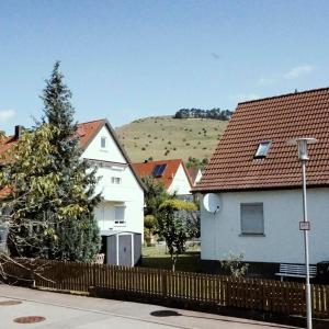 a group of houses with a hill in the background at Ferienhof am Ipf in Bopfingen