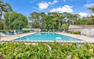 a large swimming pool with chairs at The Blue Crab in Myrtle Beach