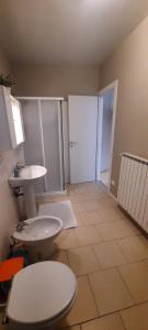 a bathroom with a toilet and a sink at Appartamenti Esmera in Desenzano del Garda +82 photos