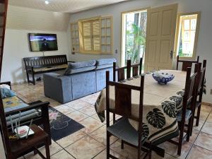 un soggiorno con un tavolo e un divano di Chalé Condomínio Vila Suiça - Balneário Rincão a Vila Nova