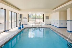 a swimming pool with blue water in a building at Courtyard by Marriott Springfield Downtown in Springfield