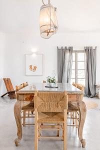 a dining room with a table and chairs at Horizon House with private pool and breathtaking views in Andiparos +24 photos
