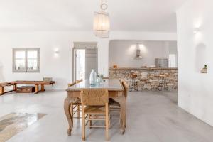 a kitchen with a wooden table and a dining room at Horizon House with private pool and breathtaking views in Andiparos